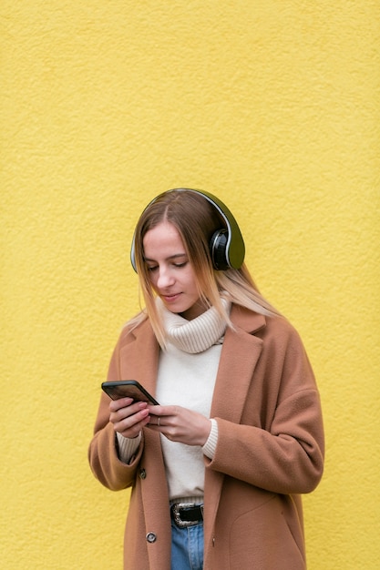 Modern woman listening to music on headphones