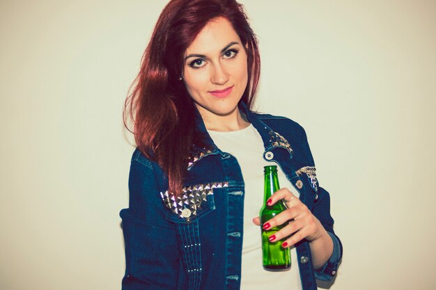 Modern woman posing with beer