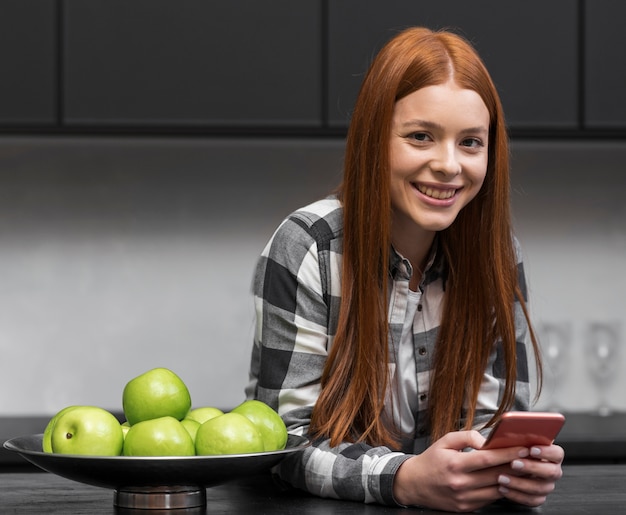 Free photo modern woman relaxing in kitchen