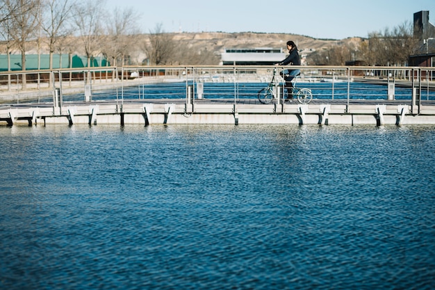 Modern woman riding bike in city