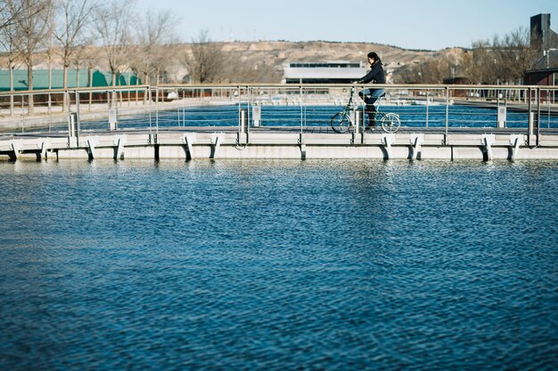 Modern woman riding bike in city