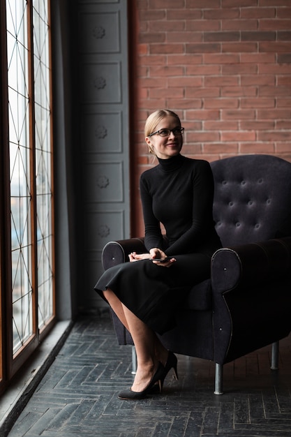 Modern woman sitting on couch