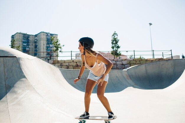 Modern woman skating with helmet