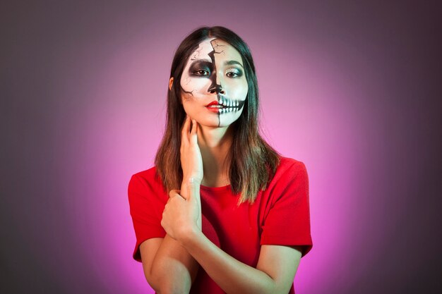 Modern woman wearing halloween mask