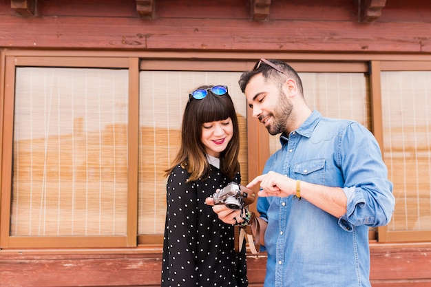 Free photo modern young couple checking photos in camera