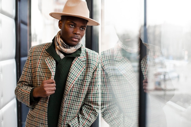 Free photo modern young male with hat and scarf posing