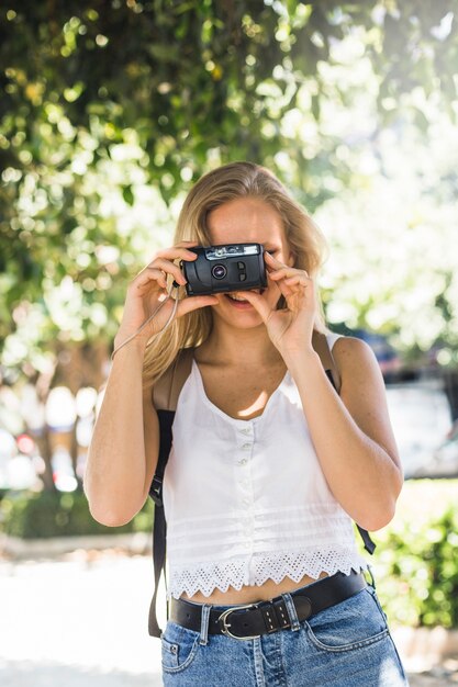 현대 젊은 여성이 디지털 카메라로 촬영