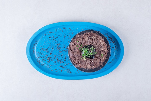 Moist chocolate sponge cake brownie on wooden plate , on the marble.