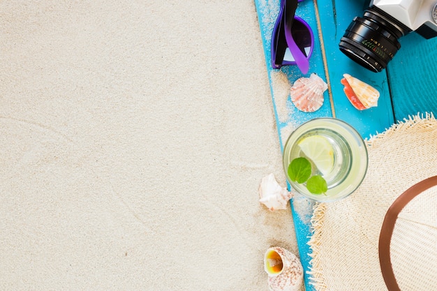 Mojito cocktail in glass with straw hat and camera