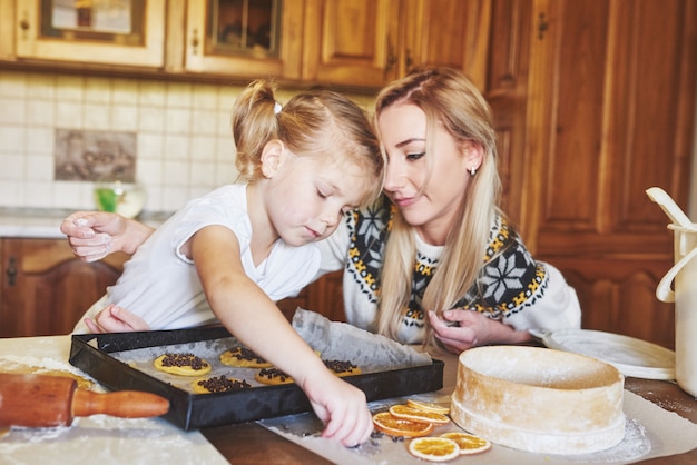 Mom and daughter are busy baking cookies