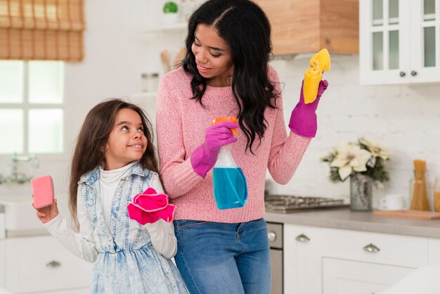 Mom and daughter cleaning the house