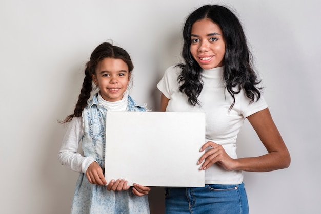 Mom and daughter holding blank paper