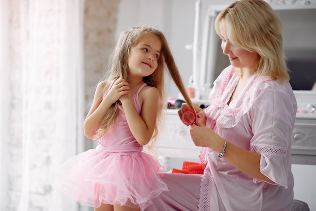 Mom and daughter at home with curlers on their heads