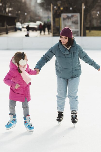 Mom and daughter ice skating