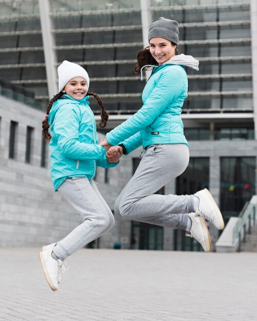 Mom and daughter jumping