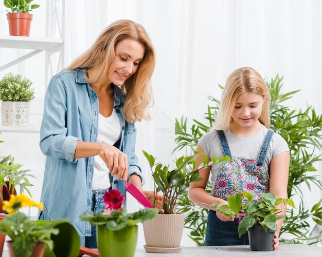 Mom and daughter planting flowers
