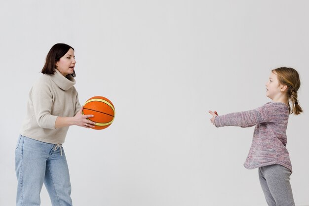 mom and daughter playing basketball