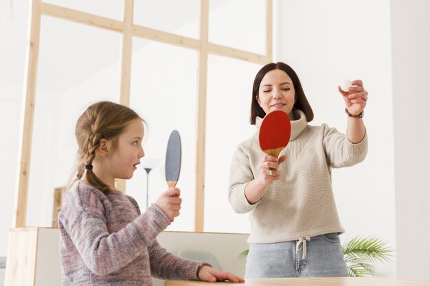 Mom and daughter playing ping pong