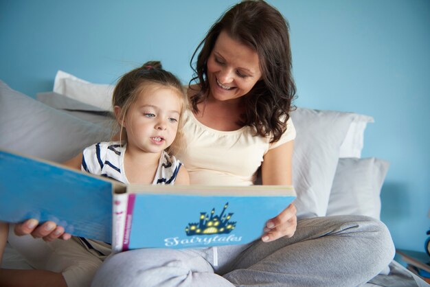 Mom and daughter reading some fairytales
