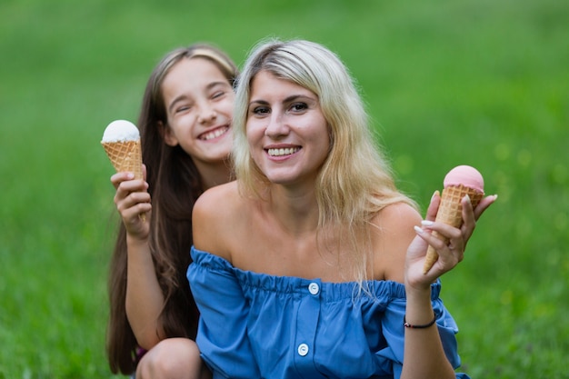 Mom and daughter with ice cream in park