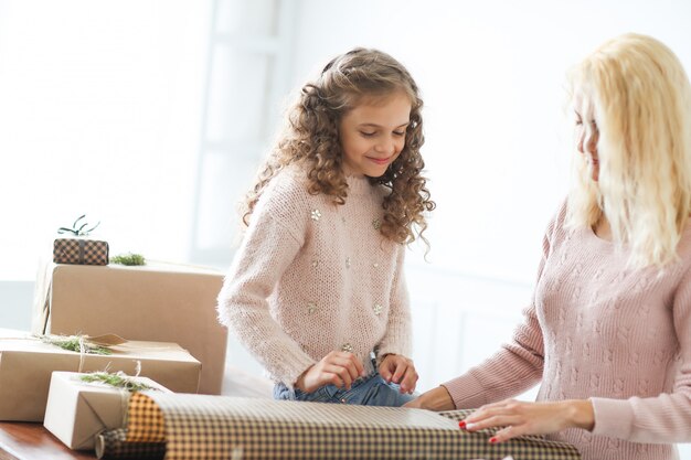 Mom and daughter wrapping presents