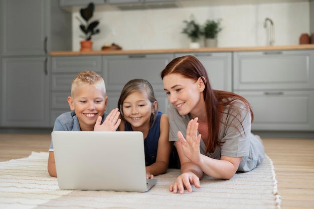 Free photo mom doing a family videocall with her kids