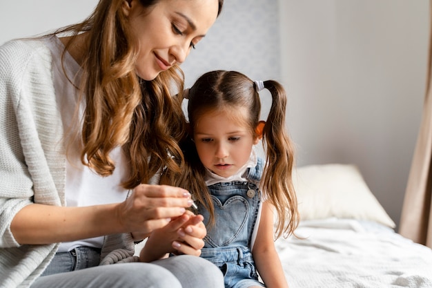 Mom doing a home covid test to her daughter