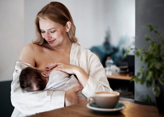 Free photo mom gently breast feeding her child