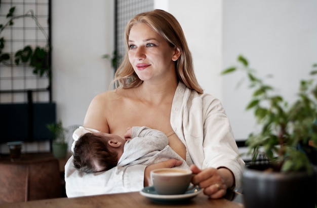 Free photo mom gently breast feeding her child