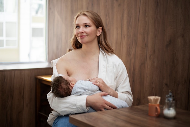 Free photo mom gently breast feeding her child