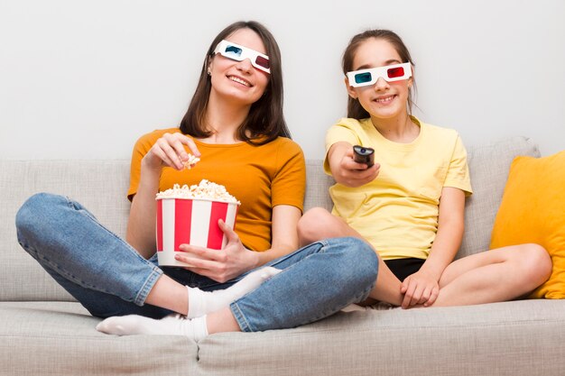 Mom and girl eating popcorn