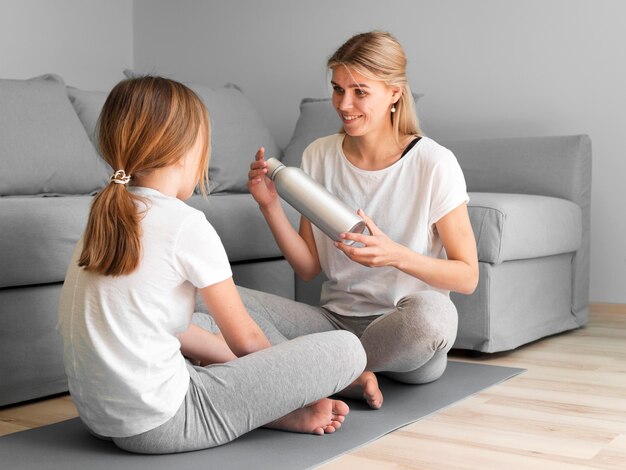 Mom and girl training on mat