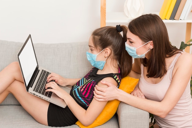 Mom and girl using laptop