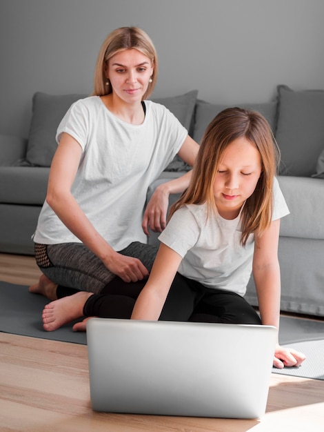 Mom and girl using laptop