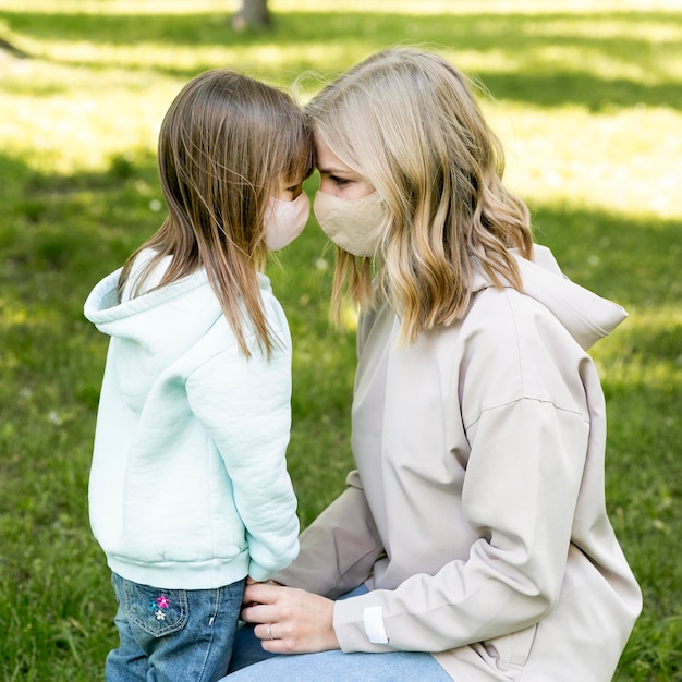 Mom and girl wearing medical mask