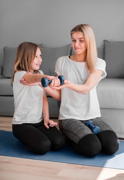 Mom and girl workout with weights