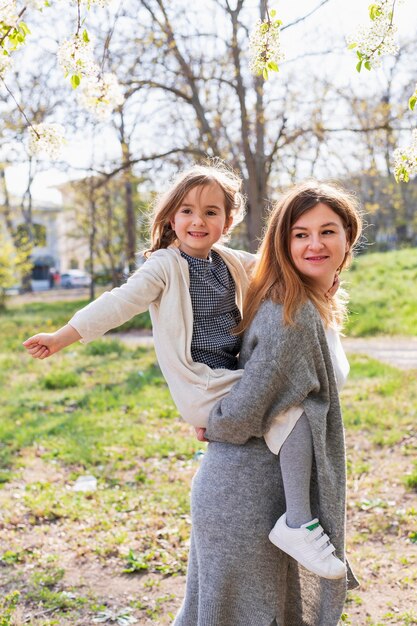 Mom giving piggyback ride to child