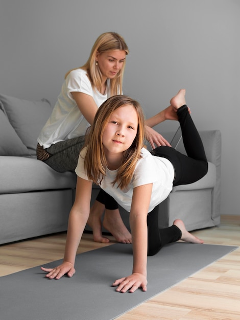 Mom help girl to workout