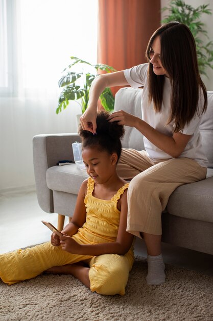 Mom helping her child styling afro hair