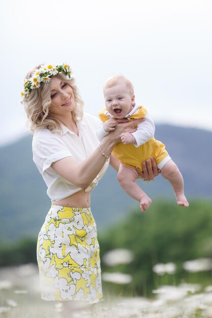 mom and her kid in camomile field