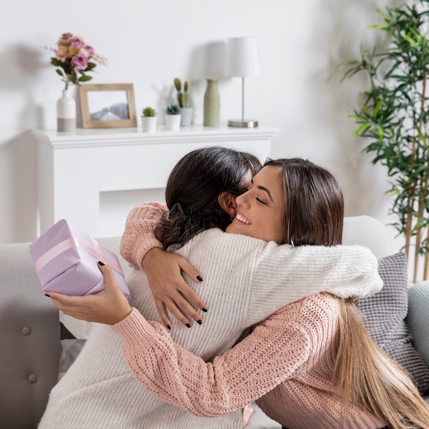 Mom hugging girl for gift