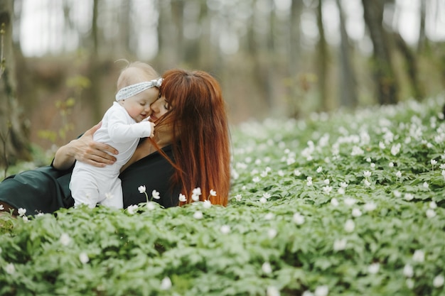 Mom hugs her little daughter with love