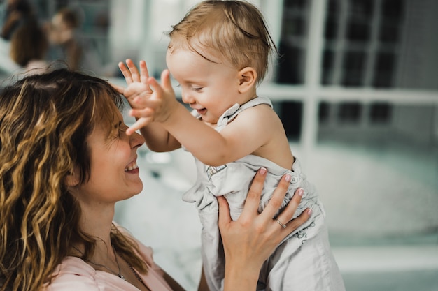 mom hugs and kisses little son