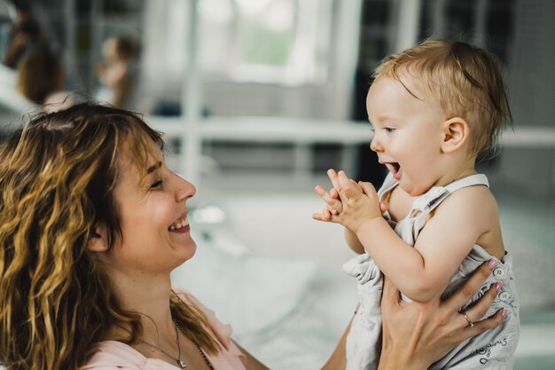 mom hugs and kisses little son