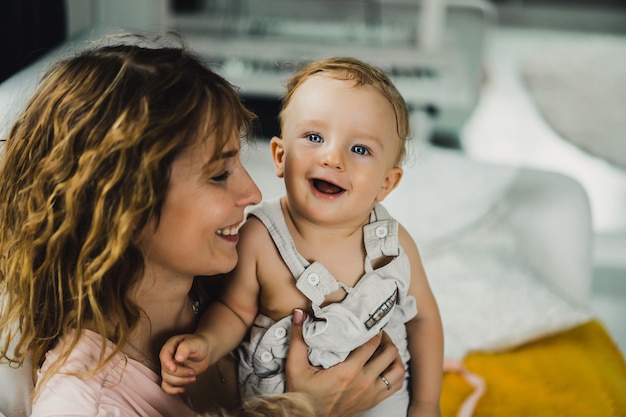 mom hugs and kisses little son