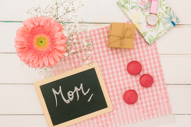 Mom inscription with gerbera and gift