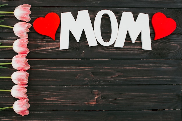 Mom inscription with tulips on table