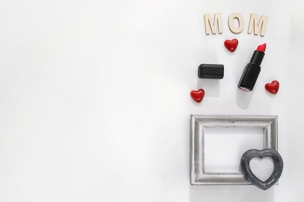 Mom lettering, lipstick and frame with heart