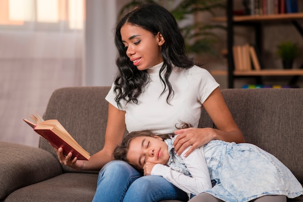 Mom reading bed story for daughter