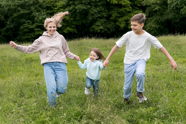 Free photo mom and siblings running